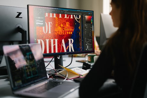 Colleague editing a book cover on the computer.